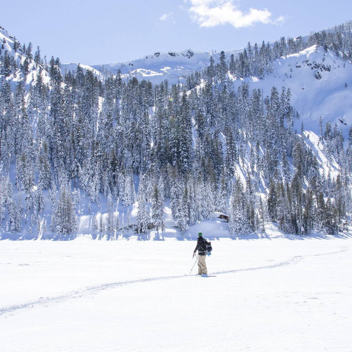 Splitborading across Echo Lake looking back at the lines made descending Talking Mountain, Lake Tahoe, Sierra Nevada, California